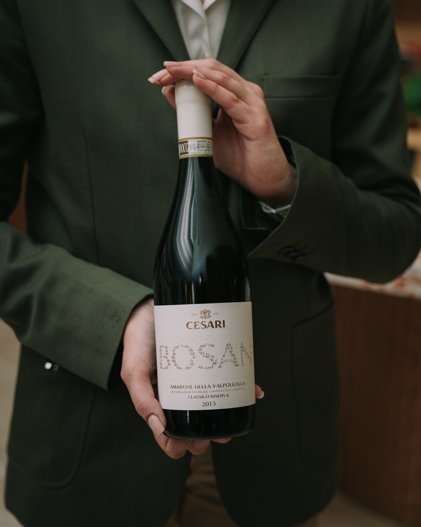 hands holding a bottle of Amarone della Valpolicella Riserva Bosan