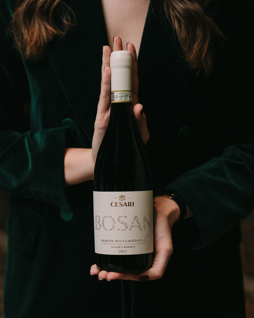 person holding a bottle of historic vintage of Amarone della Valpolicella Riserva Bosan