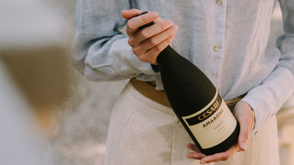 abbinamento formaggi amarone_cropped pic of a person holding a bottle of Cesari Amarone della Valpolicella